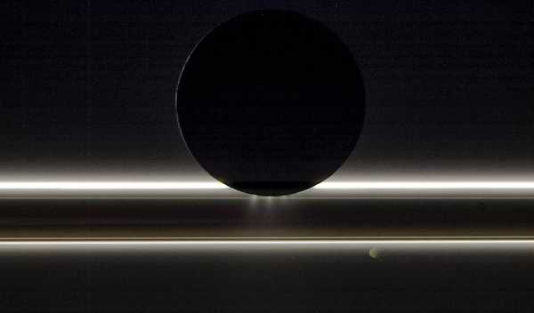 Saturn’s moon Enceladus drifts before the rings and the tiny moon Pandora, in this photo from NASA's Cassini spacecraft